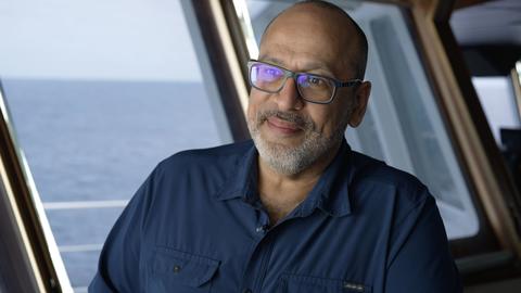 Peter Girguis, Professor at Harvard University, sits in boat, ocean in the background