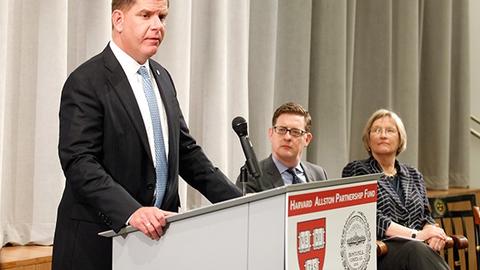 Martin J. Walsh (podium) during the announcement of the grants