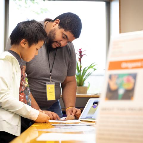 Mentor and mentee read together at a table