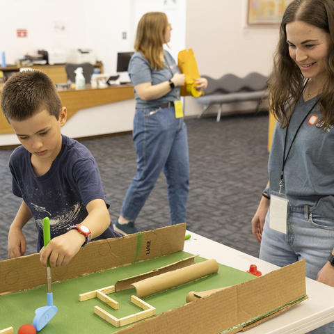 mentor-works with student on mini golf project
