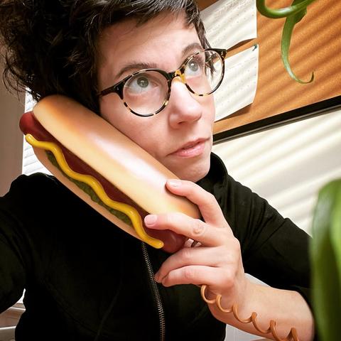 sara dudek holds hot dog phone for portrait