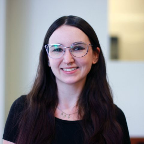 Headshot of artist Maria Cuneo wearing glasses and smiling