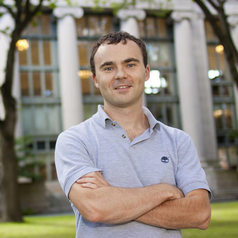 Professor Conor Walsh poses outside in front of building