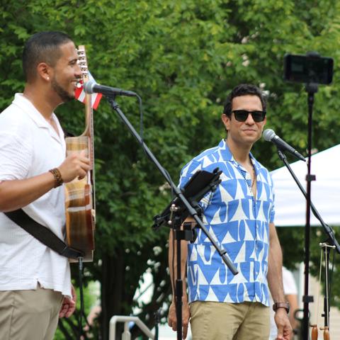 Juan Nieves band on stage at microphones
