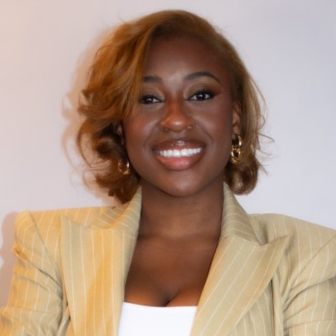 woman smiling wearing yellow blazer