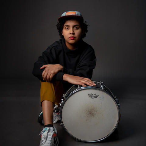 person poses with a drum