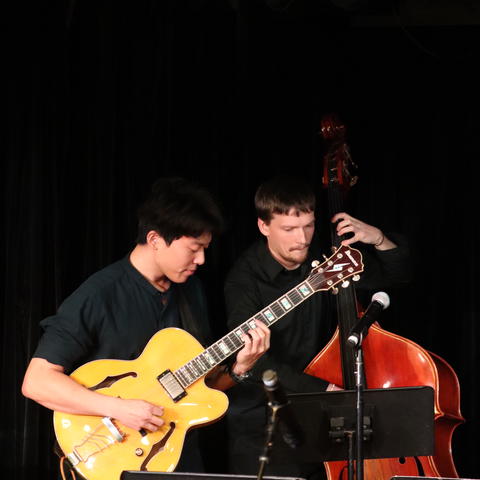 people playing instruments, one guitar and a cello