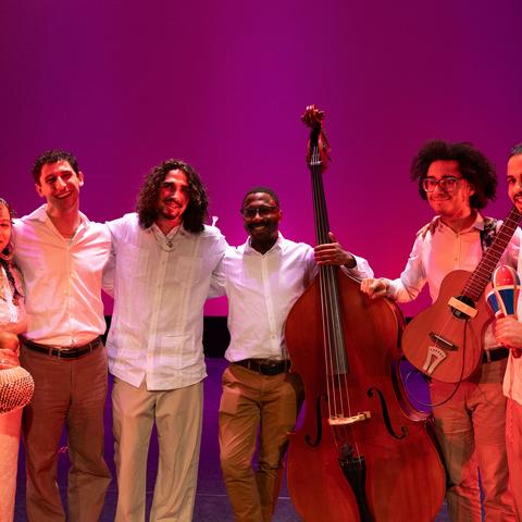 Group picture of musical band , holding various instruments