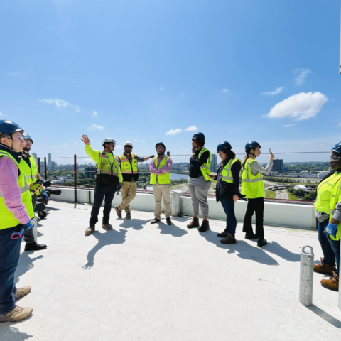 People on construction site wearing safety vests