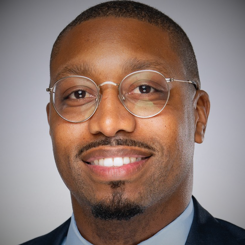 headshot of man wearing glasses