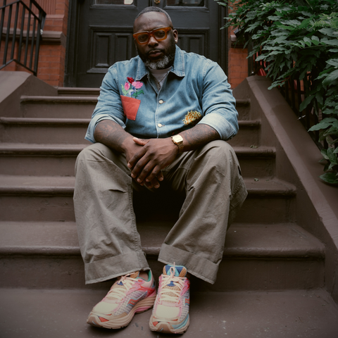 Man sits on stoop in front of building