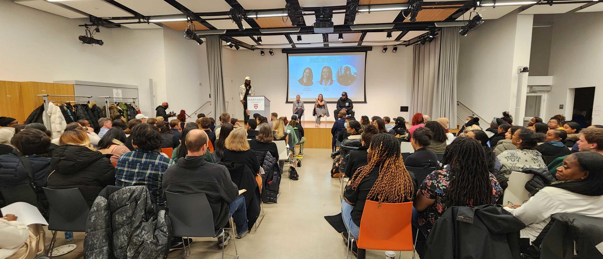 seated people attending a lecture in a room 